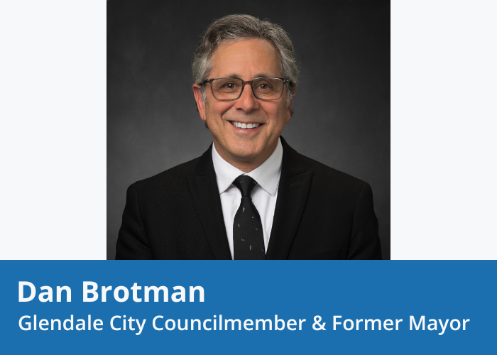 Portrait of a man with grey hair in a black suit and tie, with a white shirt and glasses, smiling. Blue banner at Bottom with white text "Dan Brotman Glendale City Councilmember & Former Mayor"